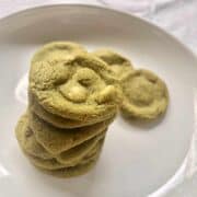 Matcha cookies with white chocolate on a white plate.