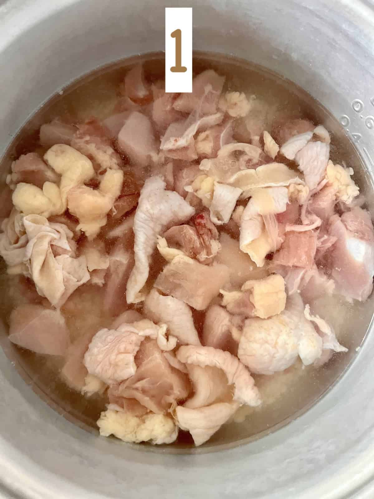 Rice and chicken in rice cooker pot.