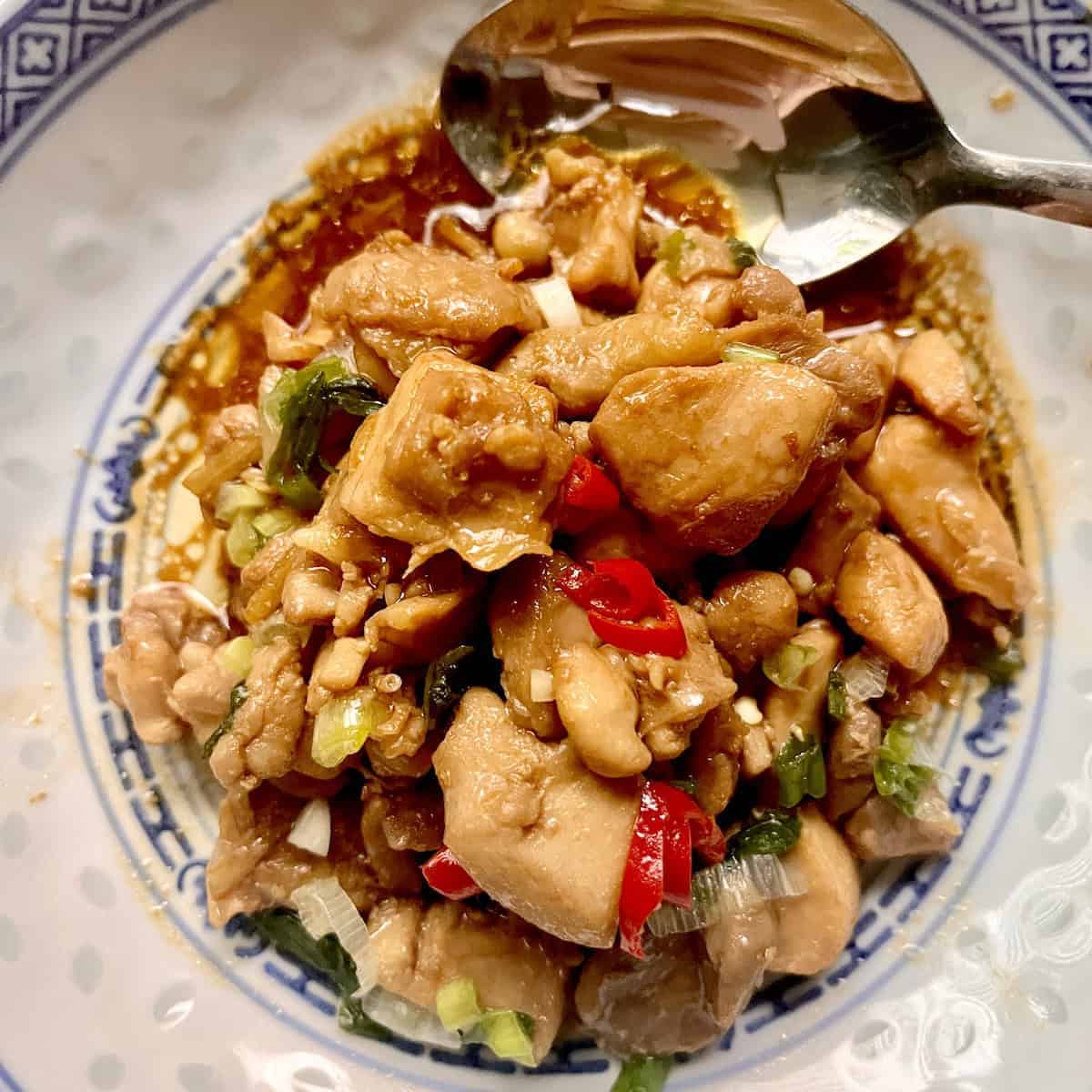 Overhead shot of a stir fried chicken with chili and ginger.