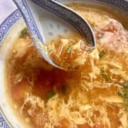 Scooping up a bowl of tomato egg drop soup.