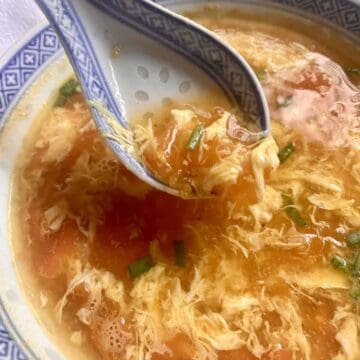 Scooping up a bowl of tomato egg drop soup.